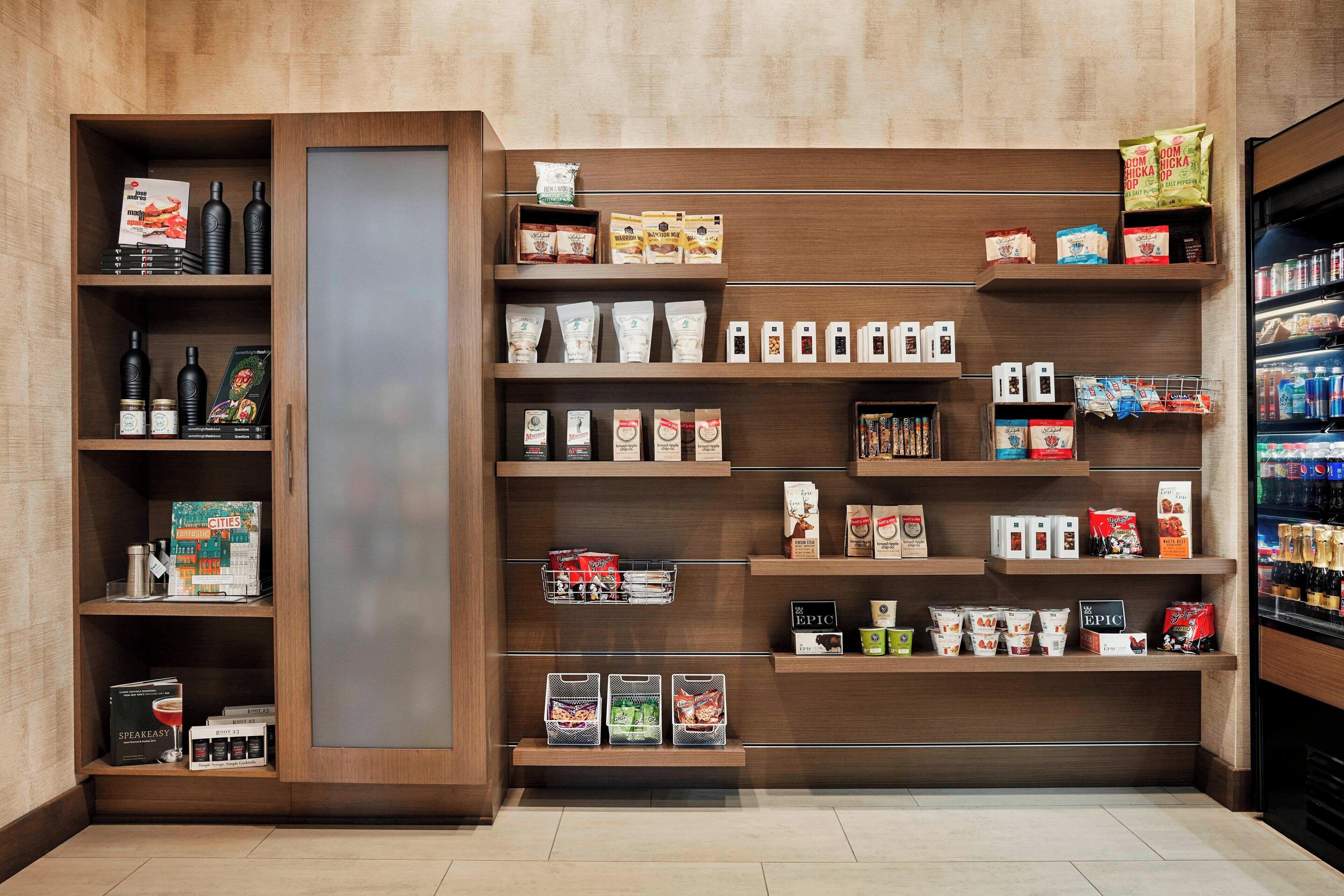 A store interior with shelves stocked with various products, including packaged goods and beverages.