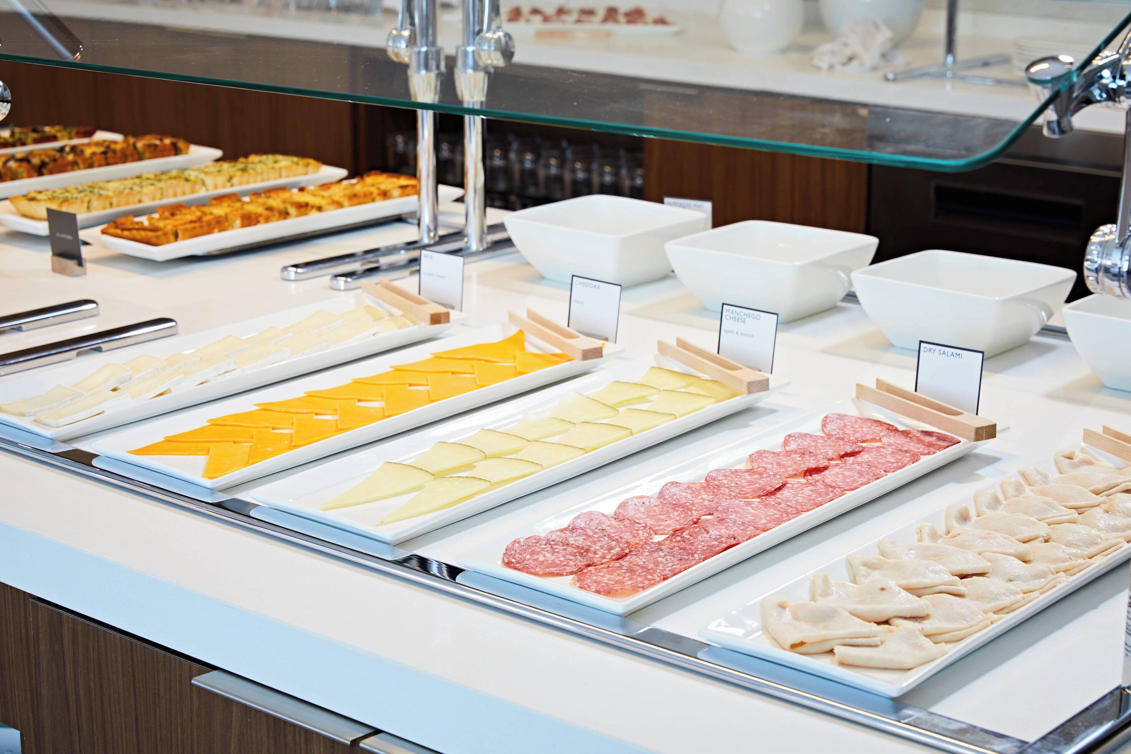 A buffet with various food items and serving utensils.