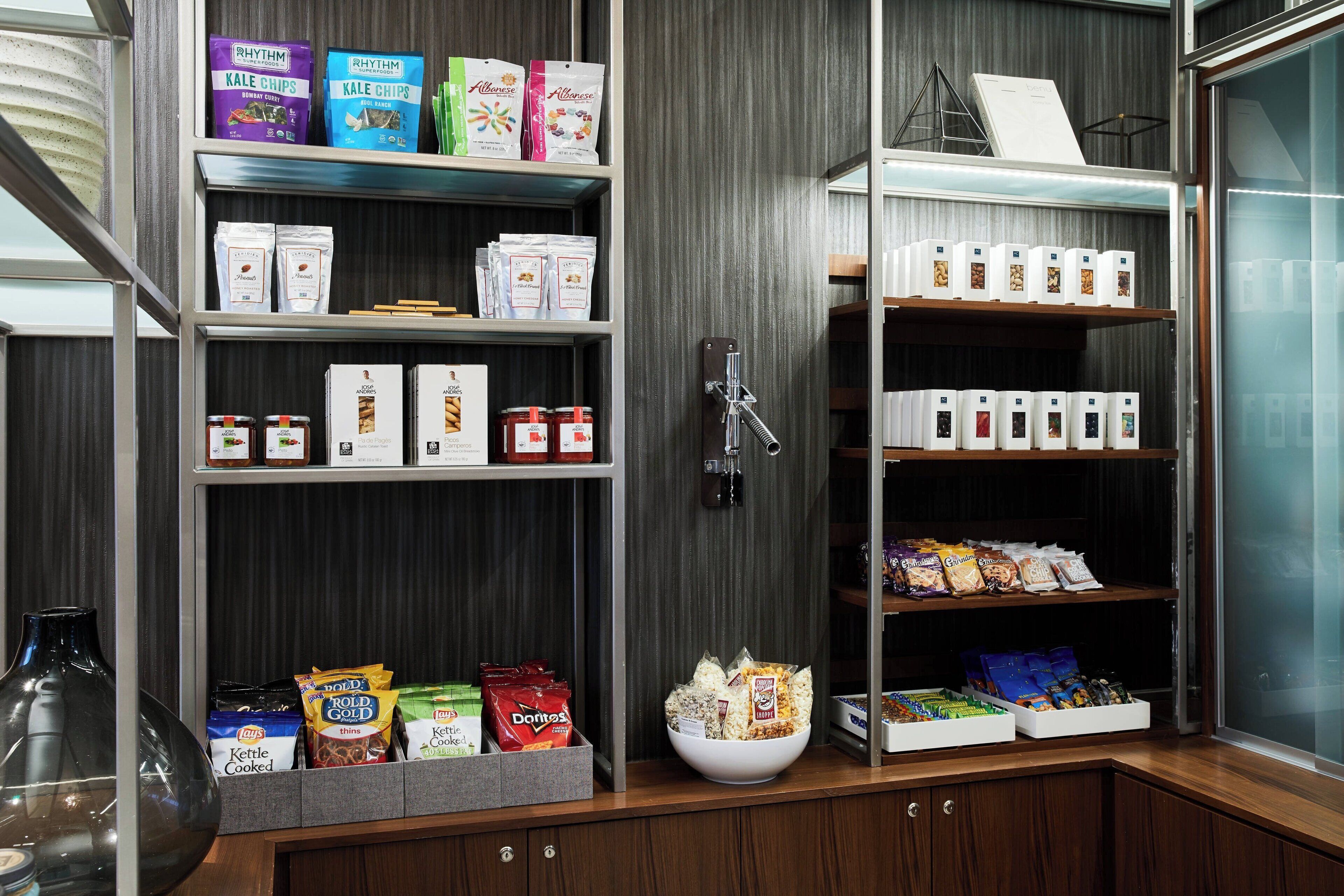 A snack bar with shelves stocked with various packaged snacks, including chips, cereals, and other food items.