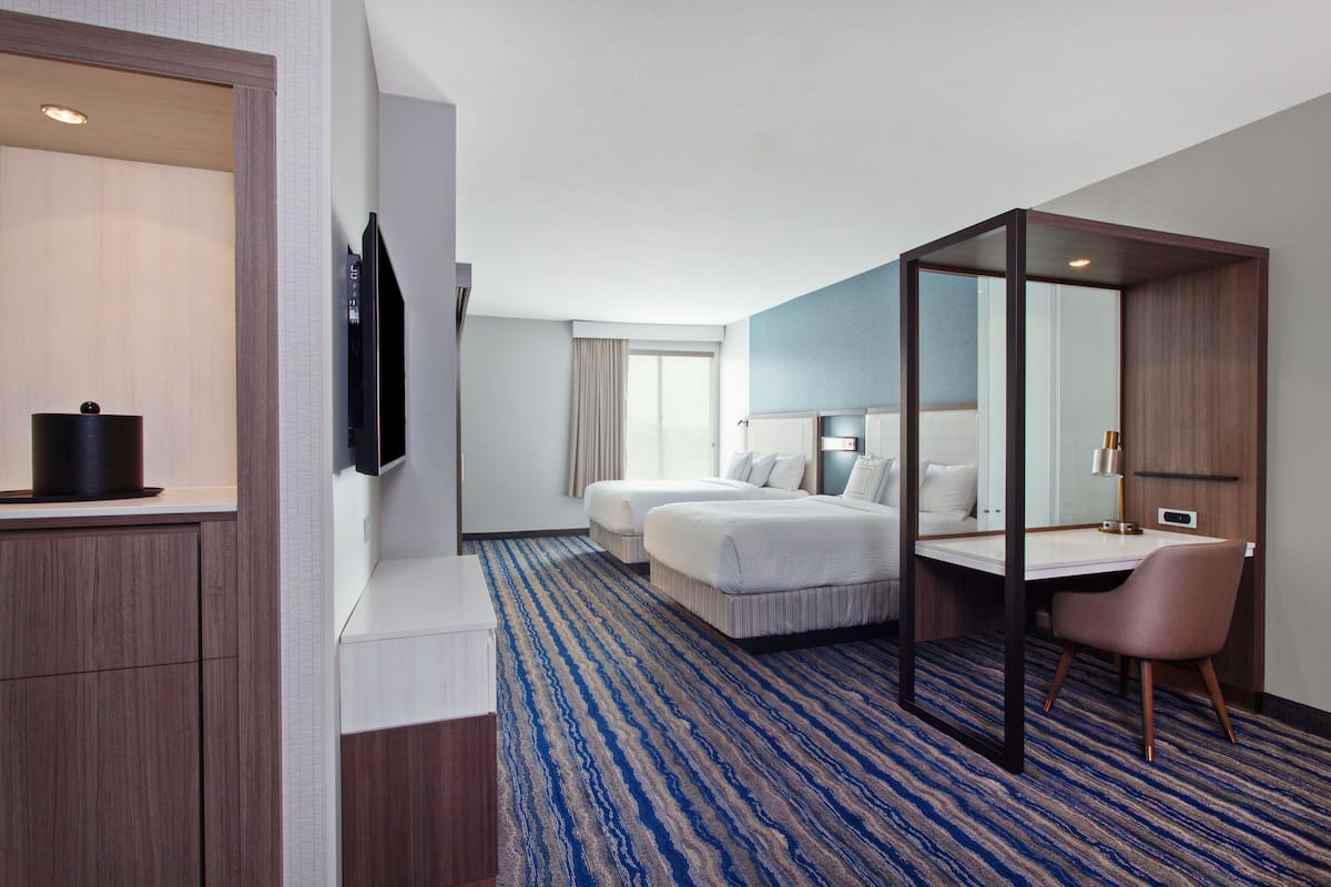 hypo-allergenic bedding, desk, laptop workspace, blackout curtains