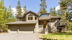 A two-story house with a garage, a covered porch, and a deck. - Sparks 7 (Bend)