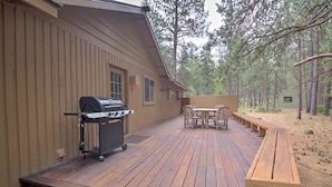 A wooden deck with a grill and outdoor furniture. - Lynx 5 (Bend)