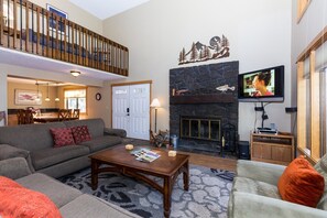 Cozy living space with a fireplace, TV, and comfortable seating area.