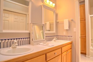 A bathroom with two sinks, a mirror, and a towel rack. - Poplar 43 (Bend)