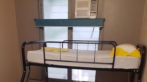 A bunk bed with two levels, each with a mattress and pillows. - Down Under Hostels on Harriet (Darwin)