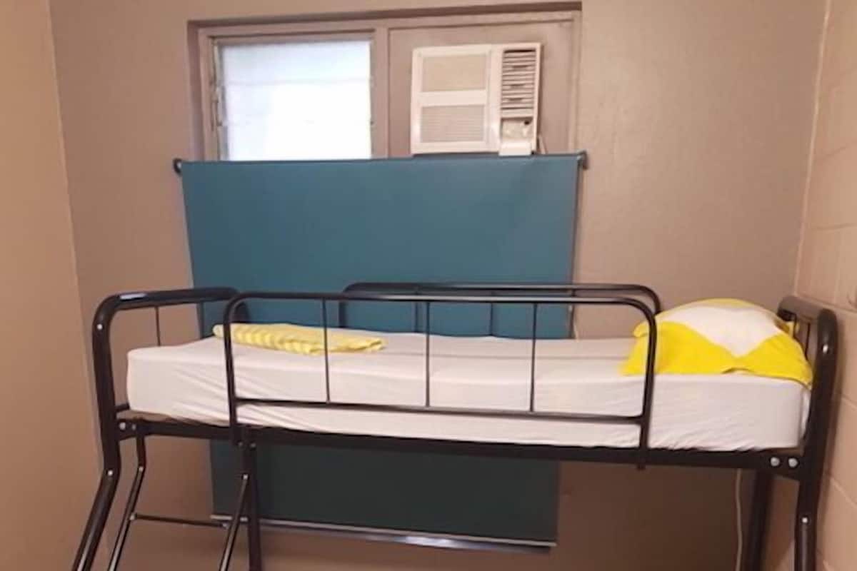 A bunk bed with two levels, each with a mattress and pillows.