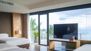 A hotel room with three beds, a TV, and a balcony with a view of the ocean. - Escala Tagaytay (Tagaytay)