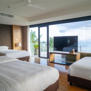 A hotel room with three beds, a TV, and a balcony with a view of the ocean. - Escala Tagaytay (Tagaytay)