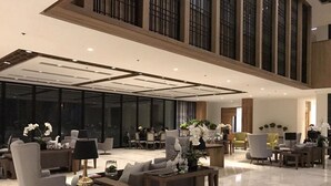 A spacious lobby with a high ceiling, modern furniture, and large windows. - Escala Tagaytay (Tagaytay)