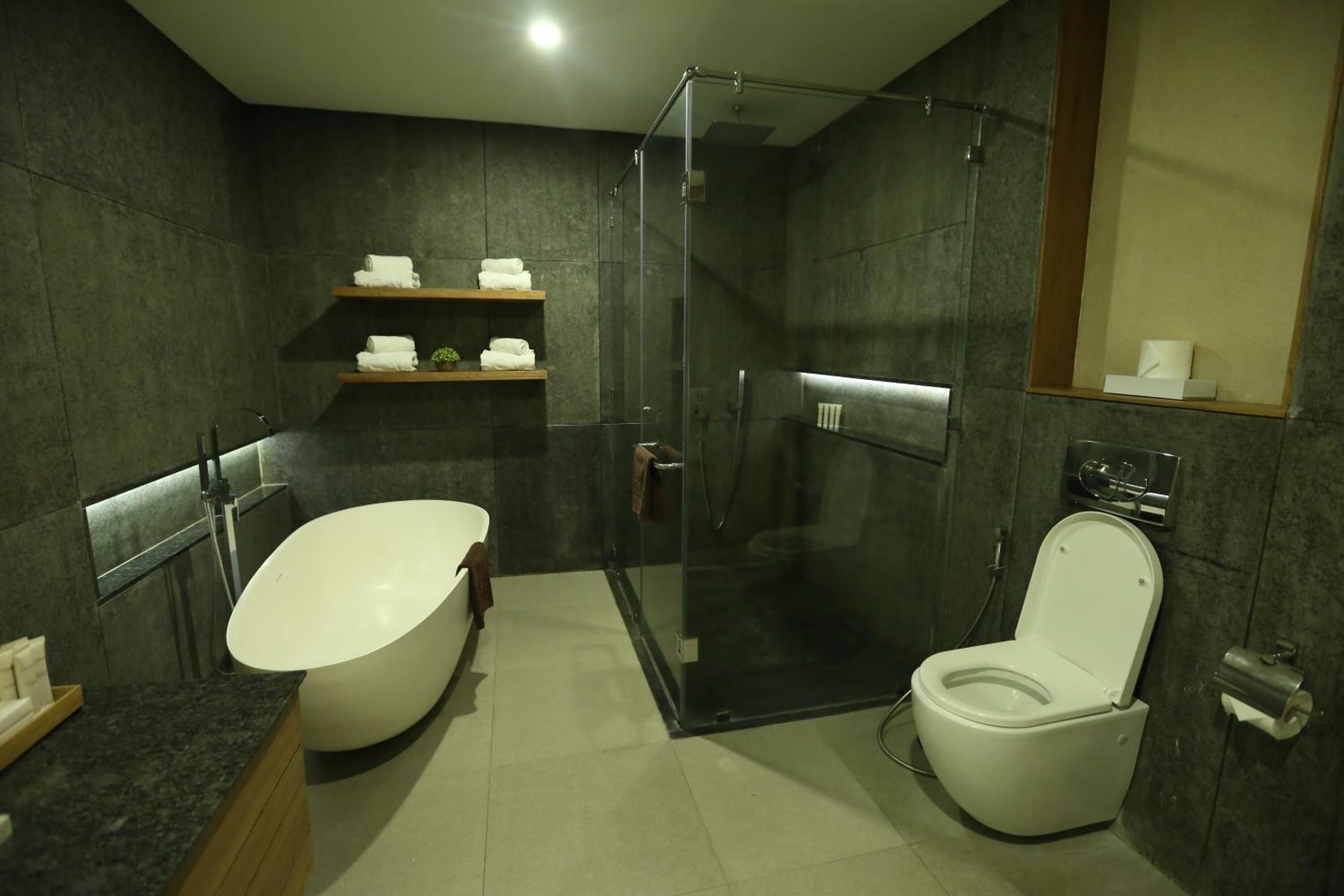 Ein modernes Badezimmer mit einer freistehenden Badewanne, einer Duschkabine und einem WC.