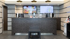 A reception area with a marble wall, a reception desk, a bench, and two pendant lights. - The BREAKFAST HOTEL Fukuoka Tenjin (Fukuoka)