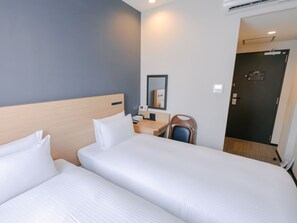 A hotel room with two beds, a desk, a chair, a mirror, and a door. - The BREAKFAST HOTEL Fukuoka Tenjin (Fukuoka)