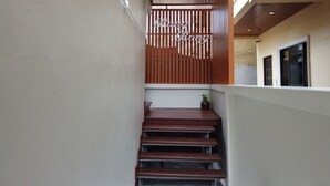 A narrow staircase with wooden steps and a wooden railing. - RangRong Hotel (Patong)