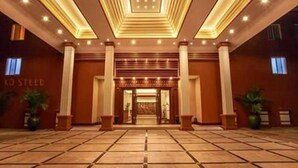 A hotel entrance with a tiled floor, large columns, and a sign that reads "KO STEED". - Golden Hotel (Mandalay)