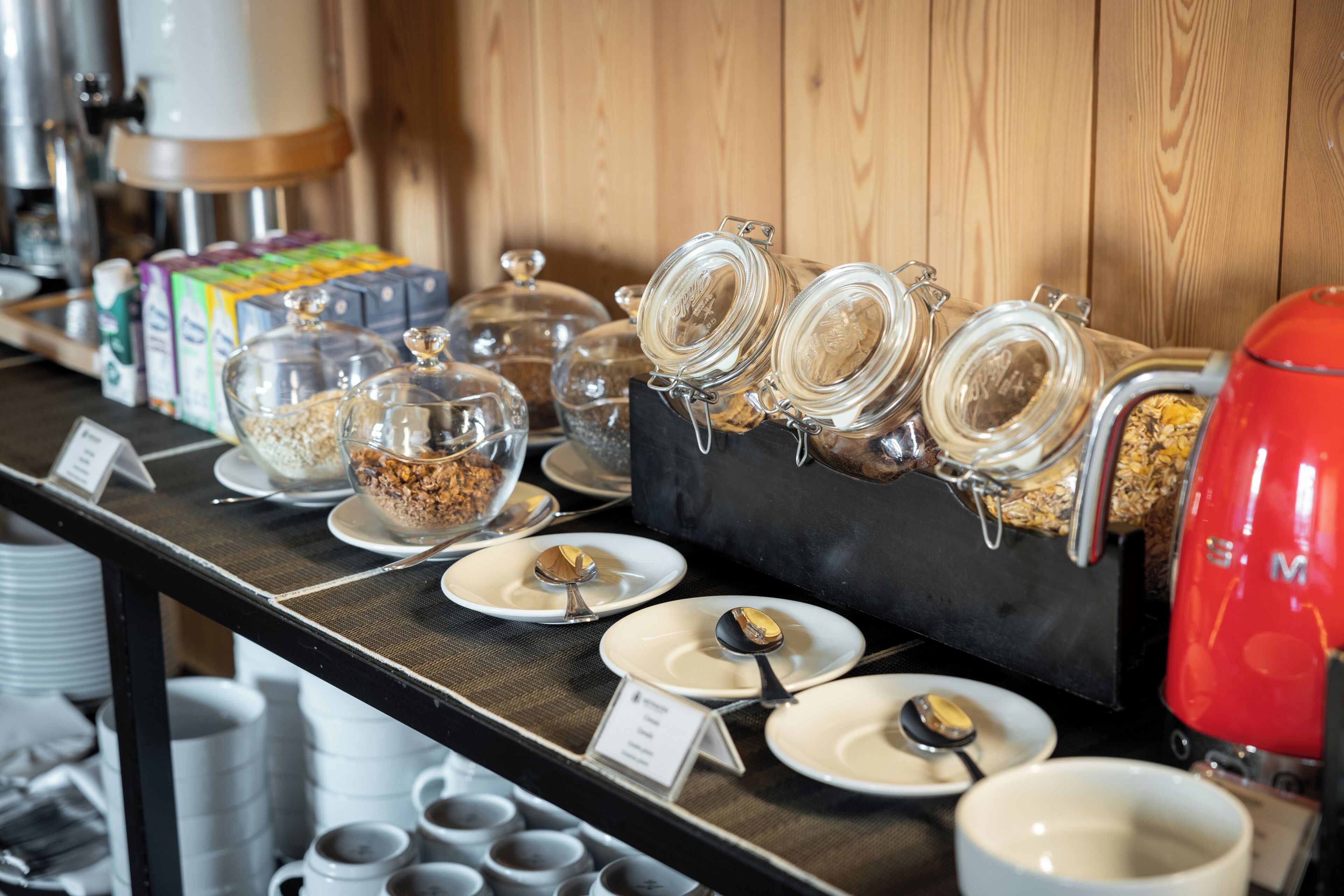 A buffet setup with various food items and containers.
