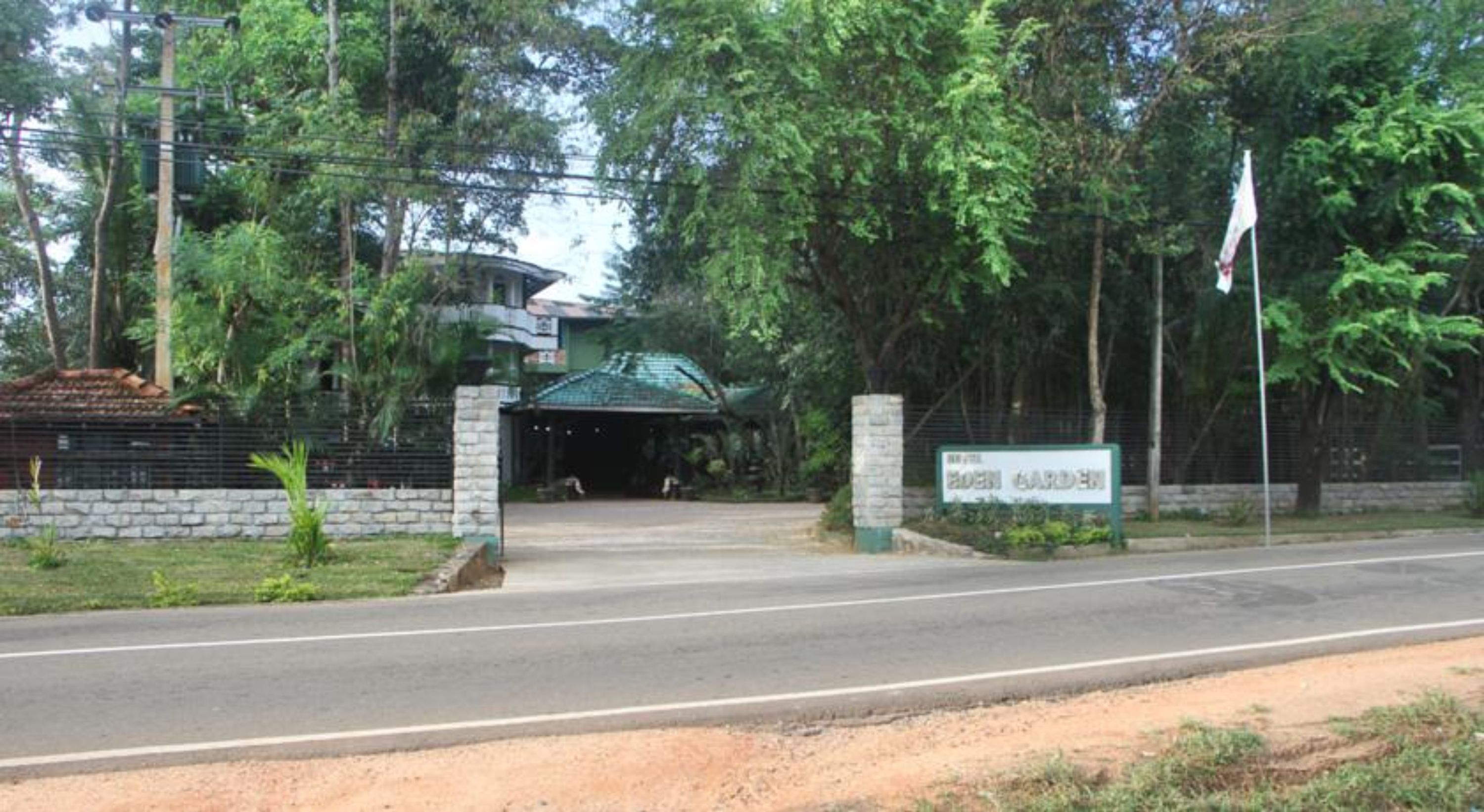 A gated entrance with a sign reading "BIRD GARDEN."