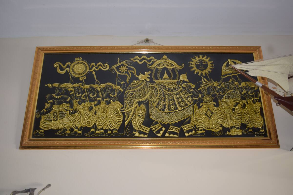 A framed artwork with intricate designs and figures.