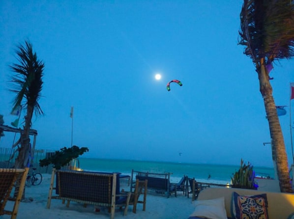 On the beach, white sand, sun loungers, beach umbrellas