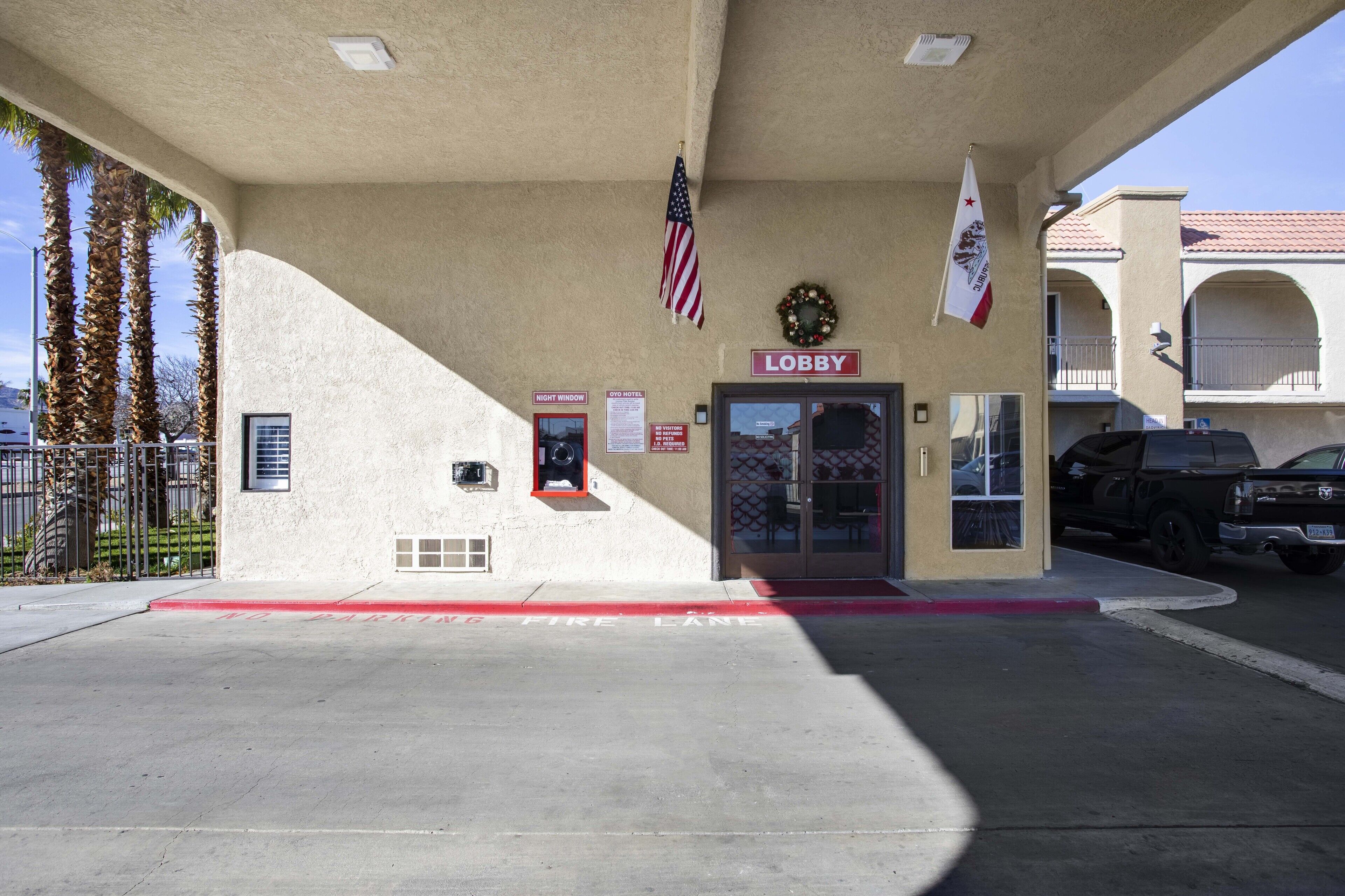 A lobby with a 'Lobby' sign, an American flag, and a fire lane.