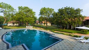 A swimming pool with a geometric design, surrounded by a patterned patio. - Chenra Hotel (Kataragama)