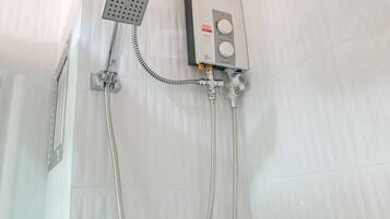 A shower with a handheld showerhead, a fixed showerhead, and a control panel.