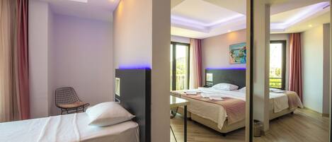 A hotel room with two beds, a chair, a desk, and a large mirror.