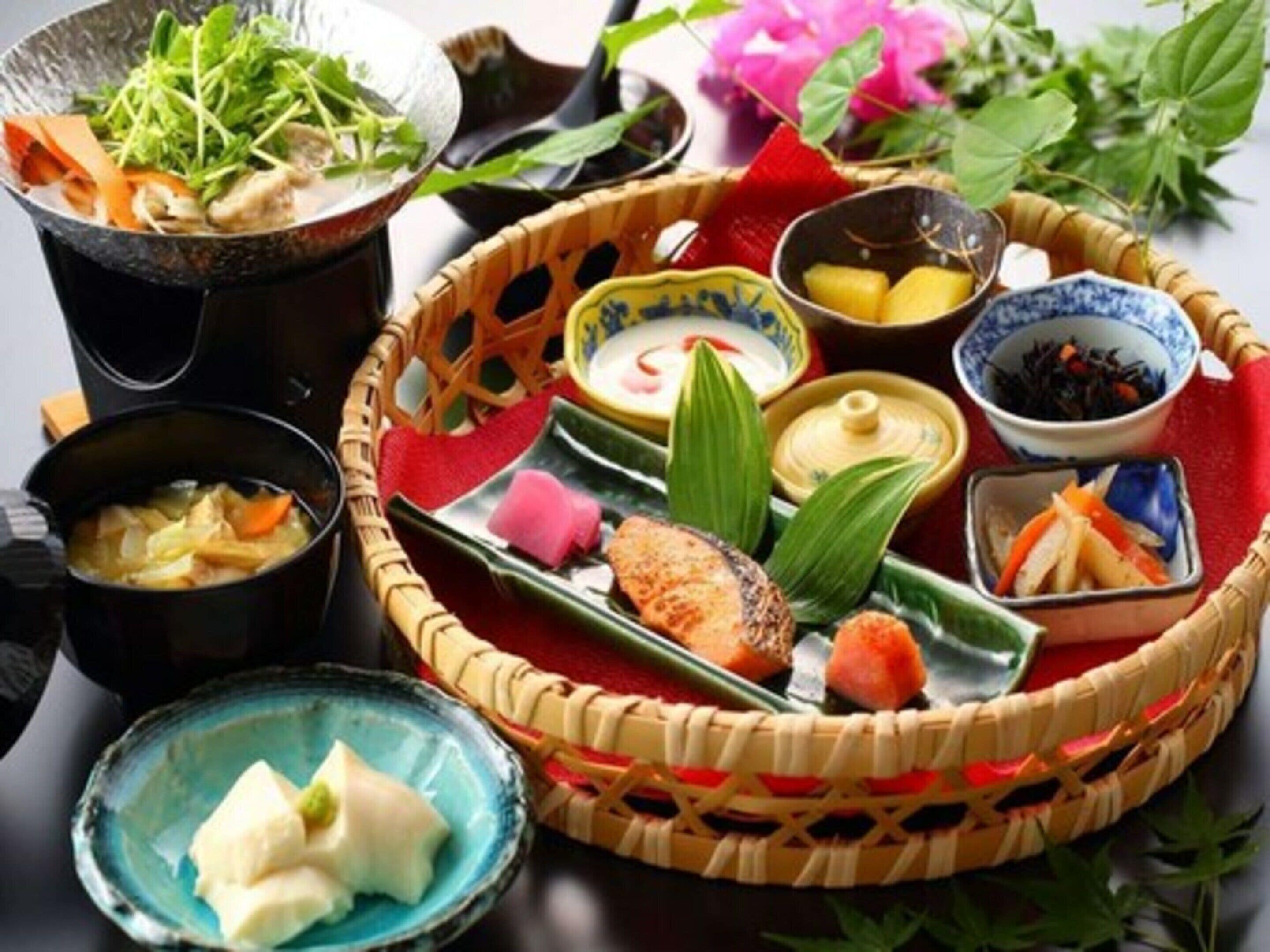 A traditional Japanese meal with various dishes and utensils.