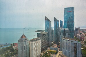 A high-rise urban area with modern skyscrapers, a waterfront, and a mix of residential and commercial buildings.
