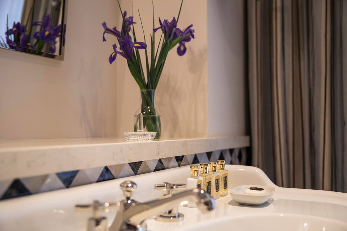 designer toiletries, hair dryer, bathrobes, slippers