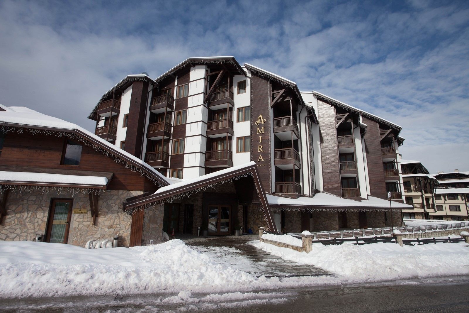 A multi-story hotel with a stone facade and balconies.