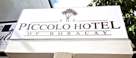 A sign for The Piccolo Hotel of Boracay.