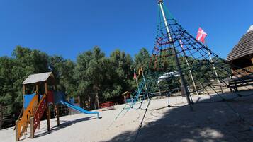 Kids can play on the slide and climbing net in this outdoor playground.