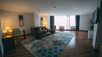 Suite, 1 Bedroom | Living room | 40-inch flat-screen TV with cable channels, TV, pay movies