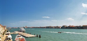 A waterfront view from an apartment with a dock, boats, and buildings in the background. - PATRIZIO panoramic view (Venice)