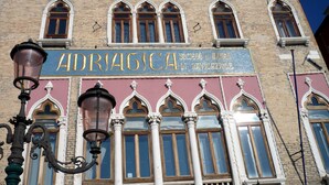 A building facade with a sign reading "ADRAGICA" and a street lamp in front. - Cross Canal Set (Venice)