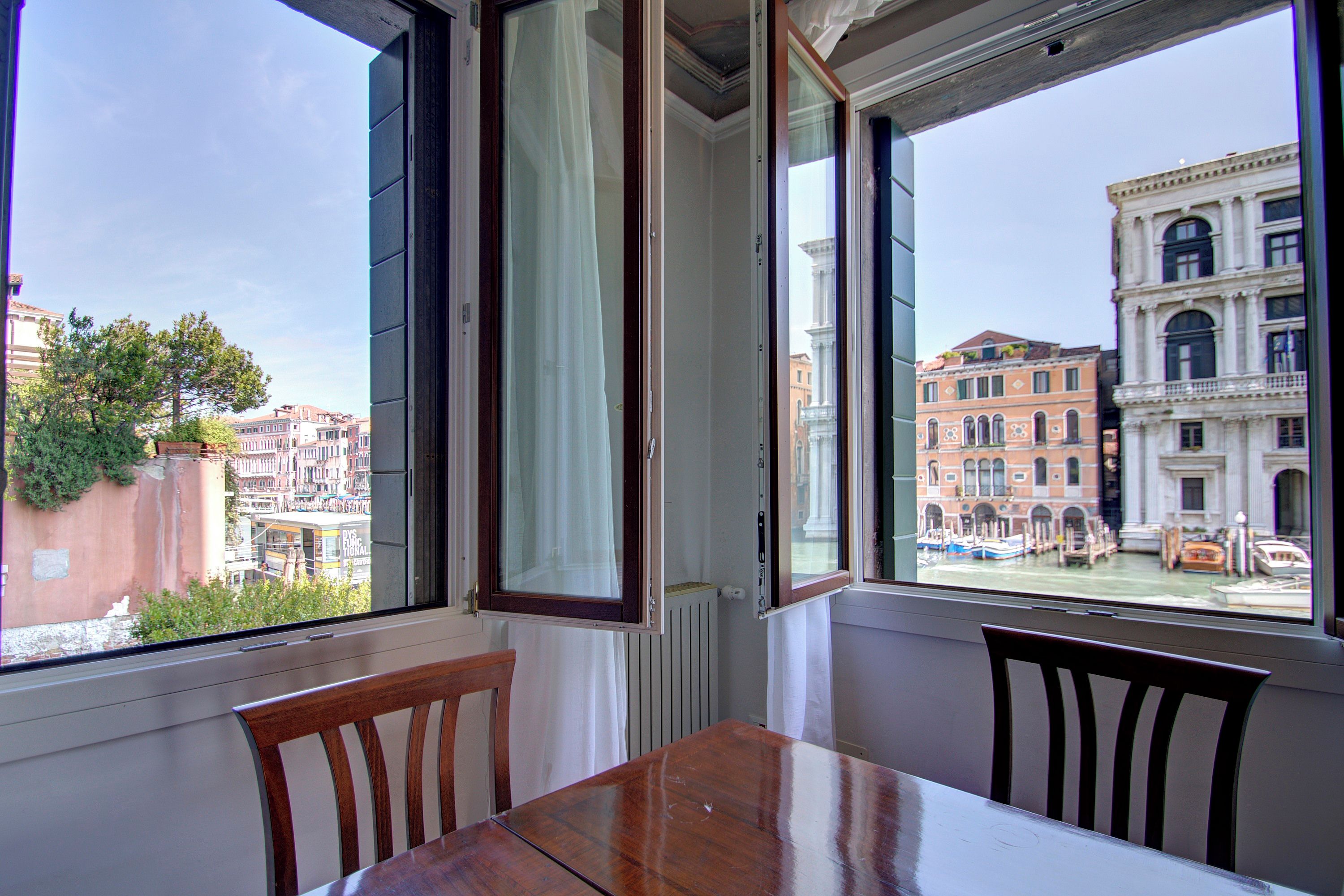 A room with a view of Venice's historic buildings and canals.