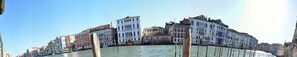 A canal with buildings along the water's edge. - TRIBUNO Grand Canal (Venice)