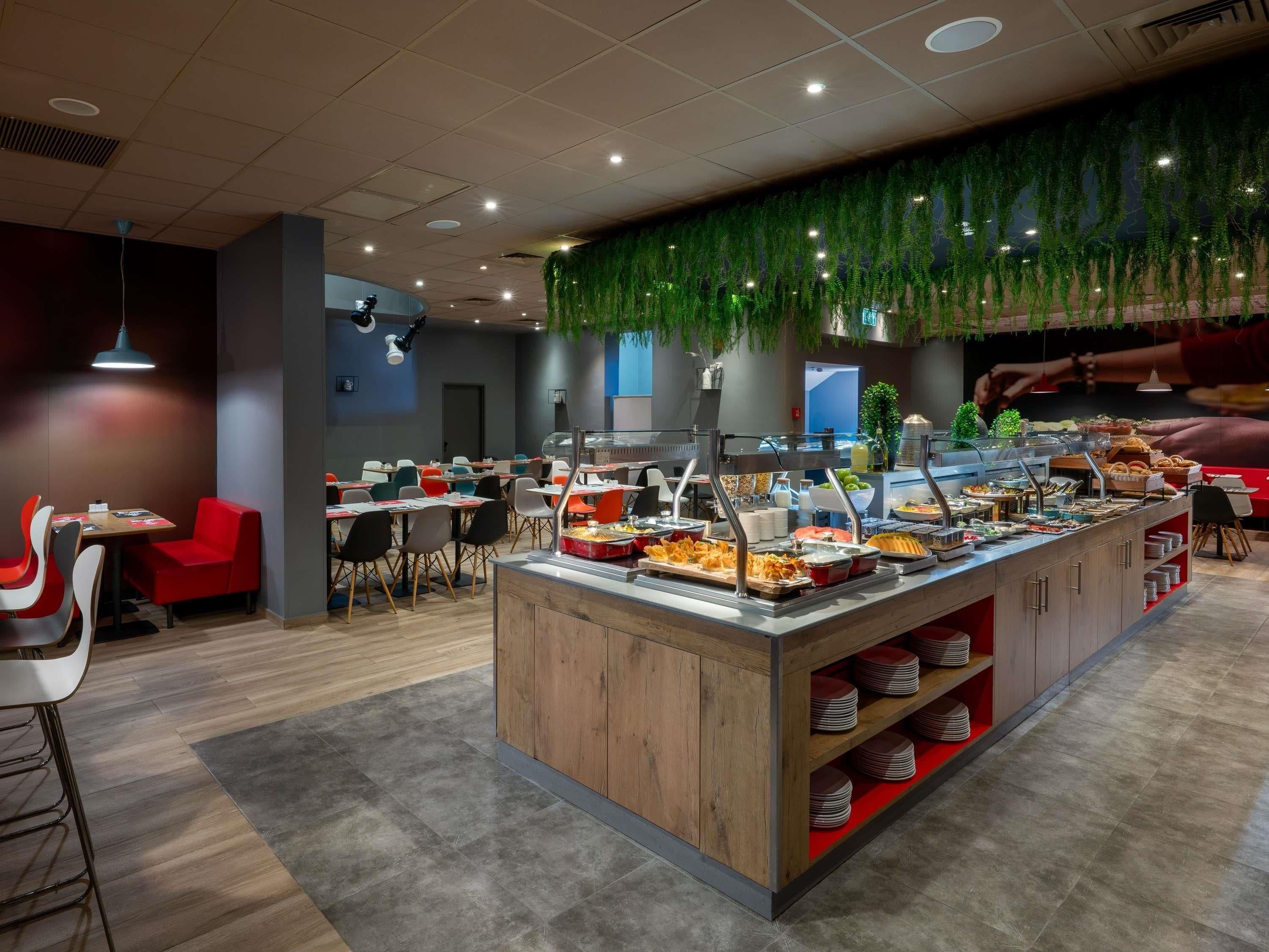 A buffet area with multiple food stations and seating arrangements.