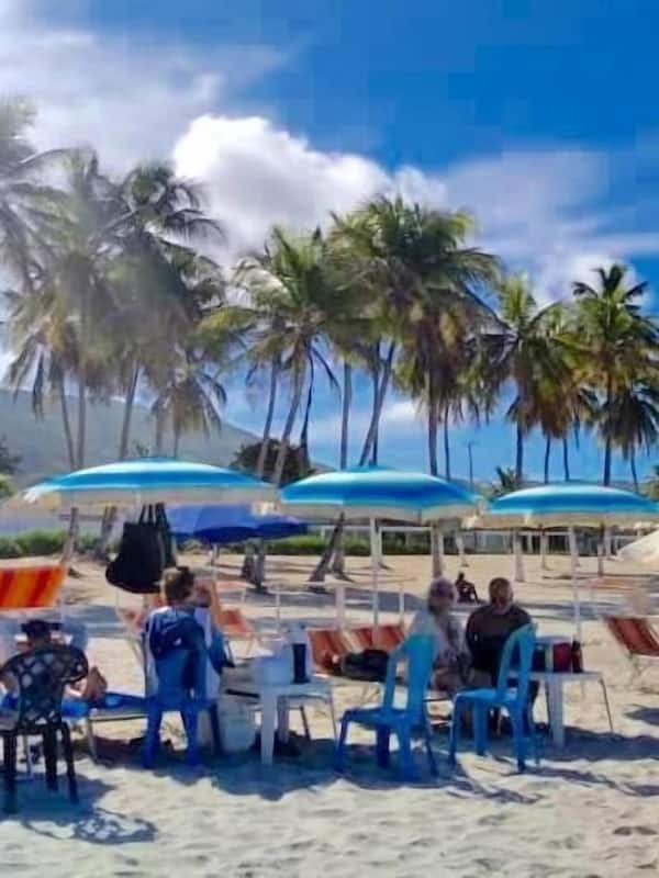 On the beach, white sand, sun-loungers, beach umbrellas