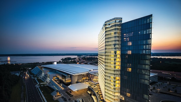 A modern hotel with a curved glass facade, a spacious lobby, and a view of the surrounding area. - MGM National Harbor Resort & Casino (Oxon Hill)