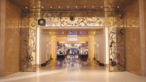A casino entrance with a modern design, featuring a large sign and decorative metalwork. - MGM National Harbor Resort & Casino (Oxon Hill)