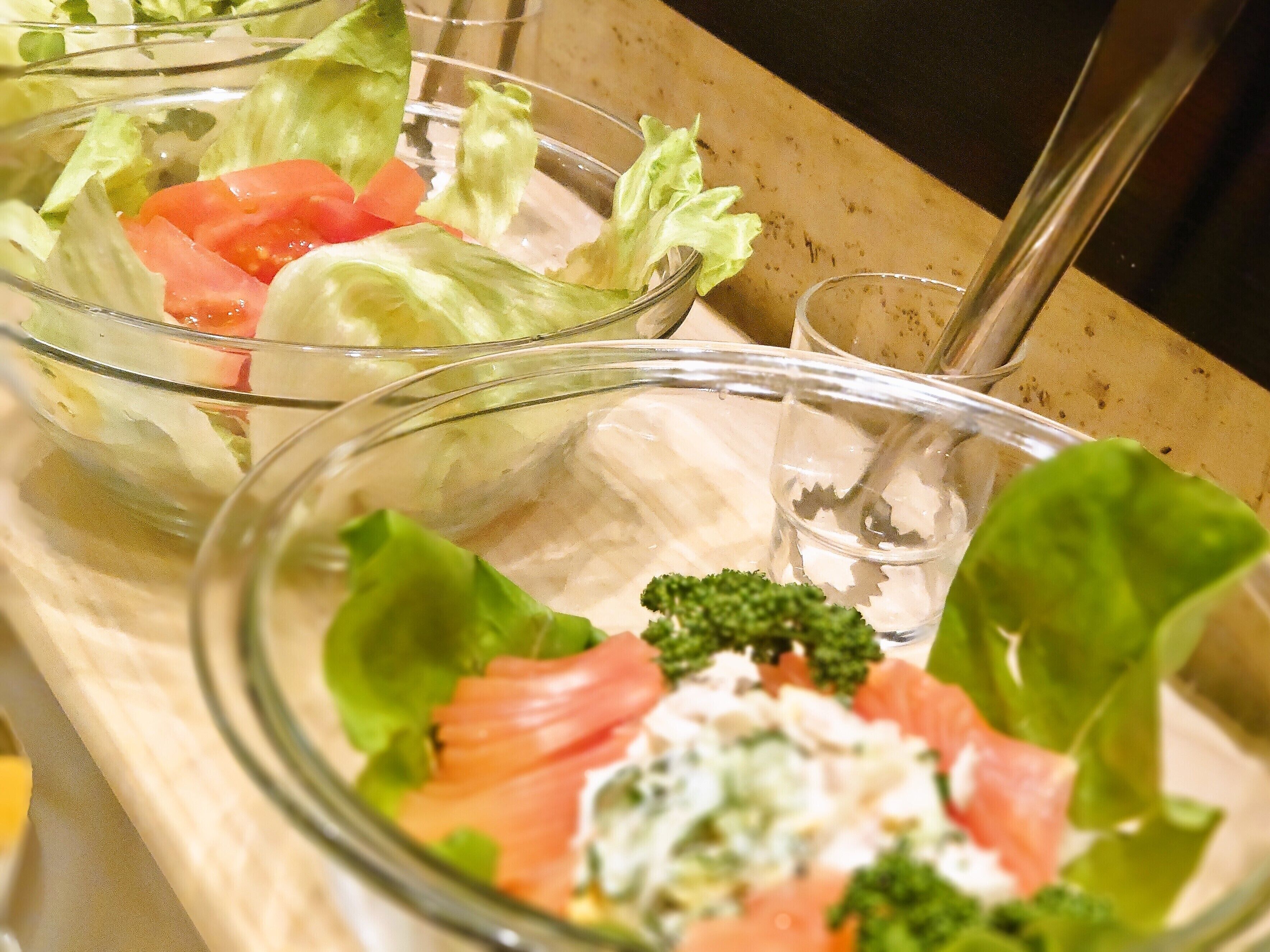 A salad with lettuce, tomatoes, and salmon.