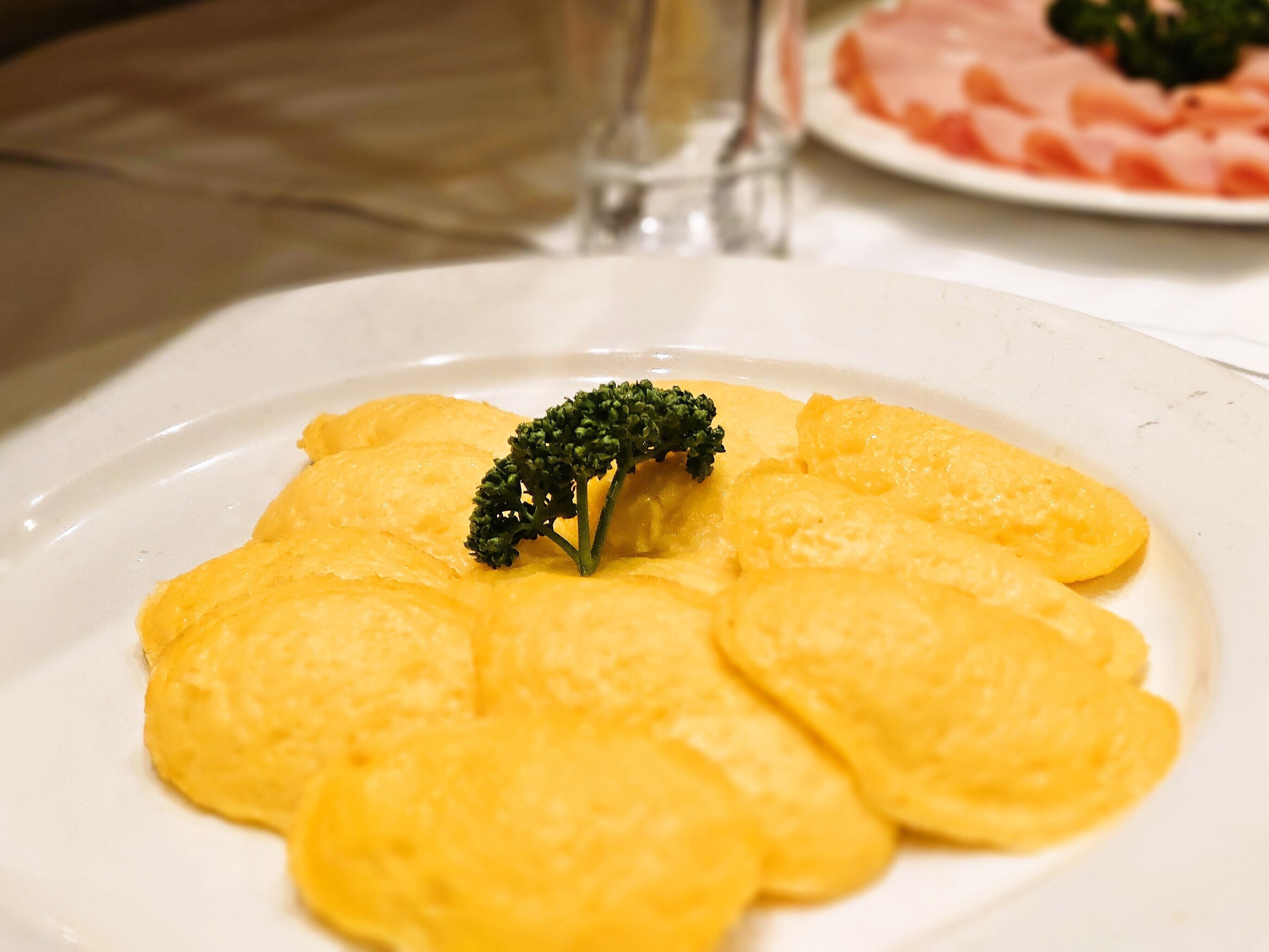 A plate of food with a garnish of broccoli.