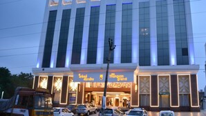 A multi-story hotel with a prominent entrance and illuminated signage. - The Thangam Grand (Madurai)