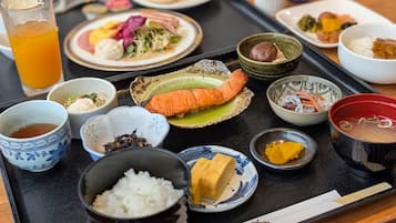 A tray with various Japanese dishes including sushi, rice, and soup.