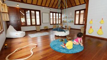 Relax in this serene space with a large window, bean bag chair, and hanging swing.