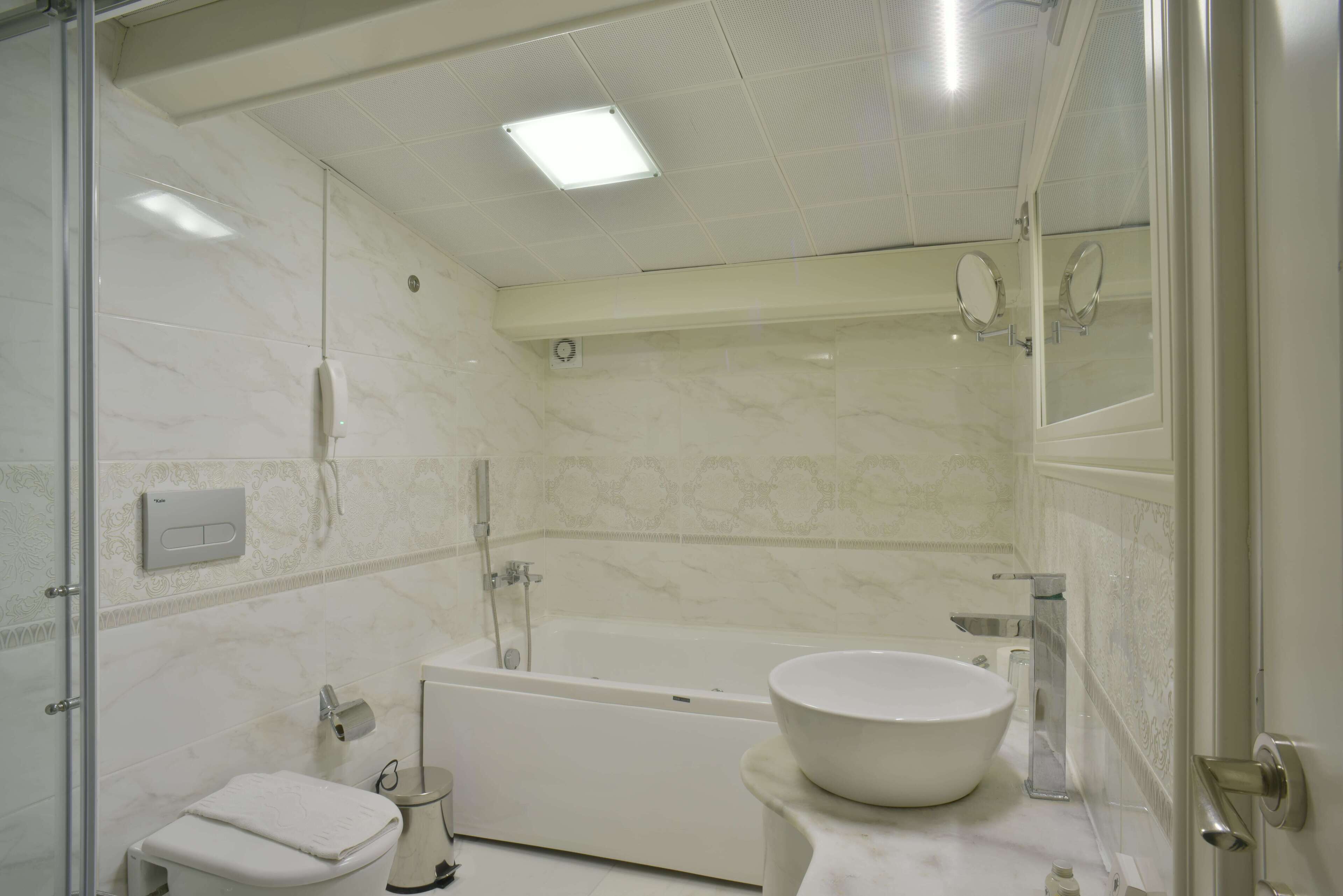 A bathroom with a bathtub, toilet, and sink.