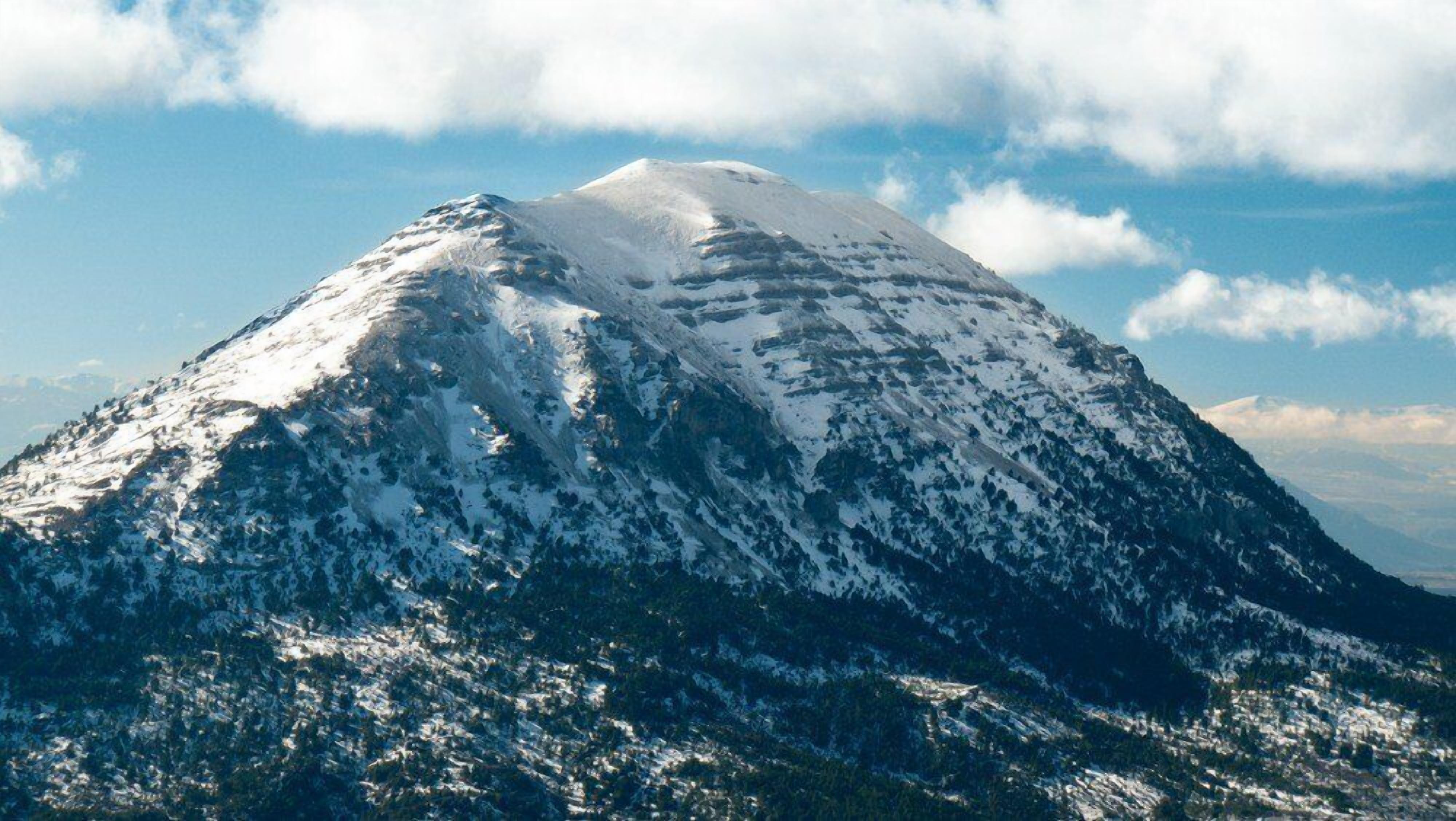 A snow-capped mountain with a clear sky.