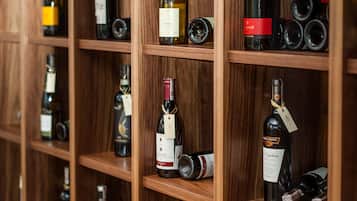 Una pared llena de botellas de vino sobre estantes de madera.