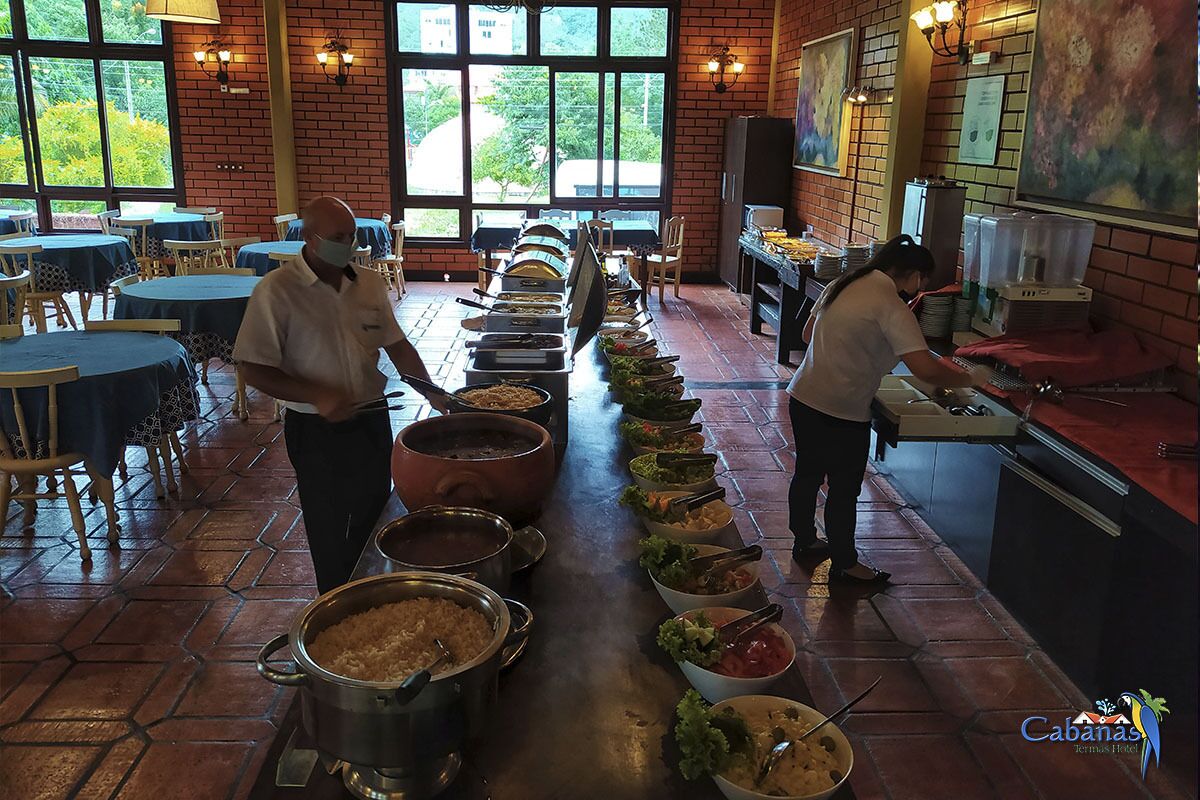 A buffet setup with multiple food stations and staff serving.